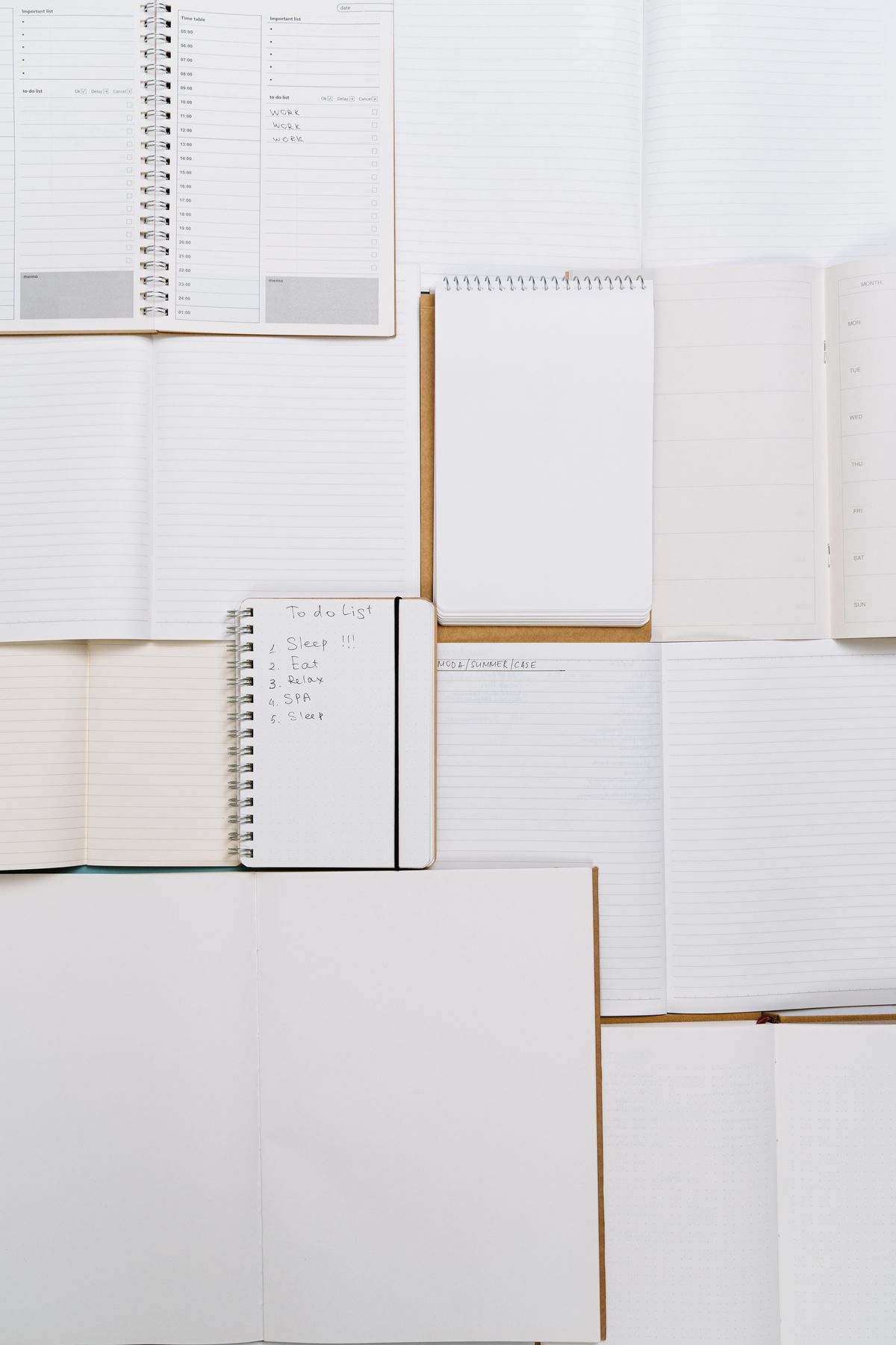 Open notebooks and planners on a desk