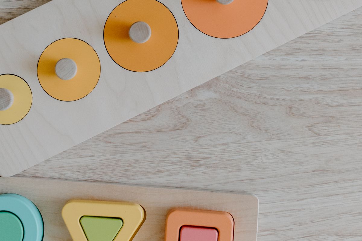 A wooden shape-sorter toy on a table